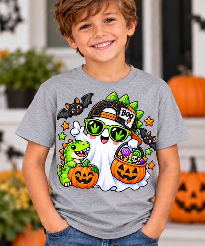 Cool ghost wearing a backwards BOO trucker cap and green dinosaur footprint sunglasses, holding a jack-o'-lantern candy bucket next to a smiling baby T-rex and pumpkin, with bats and stars on a Halloween t-shirt