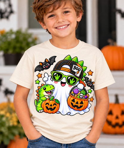 Cool ghost dinosaur Halloween tee shown in natural on a flat lay with fall decor
