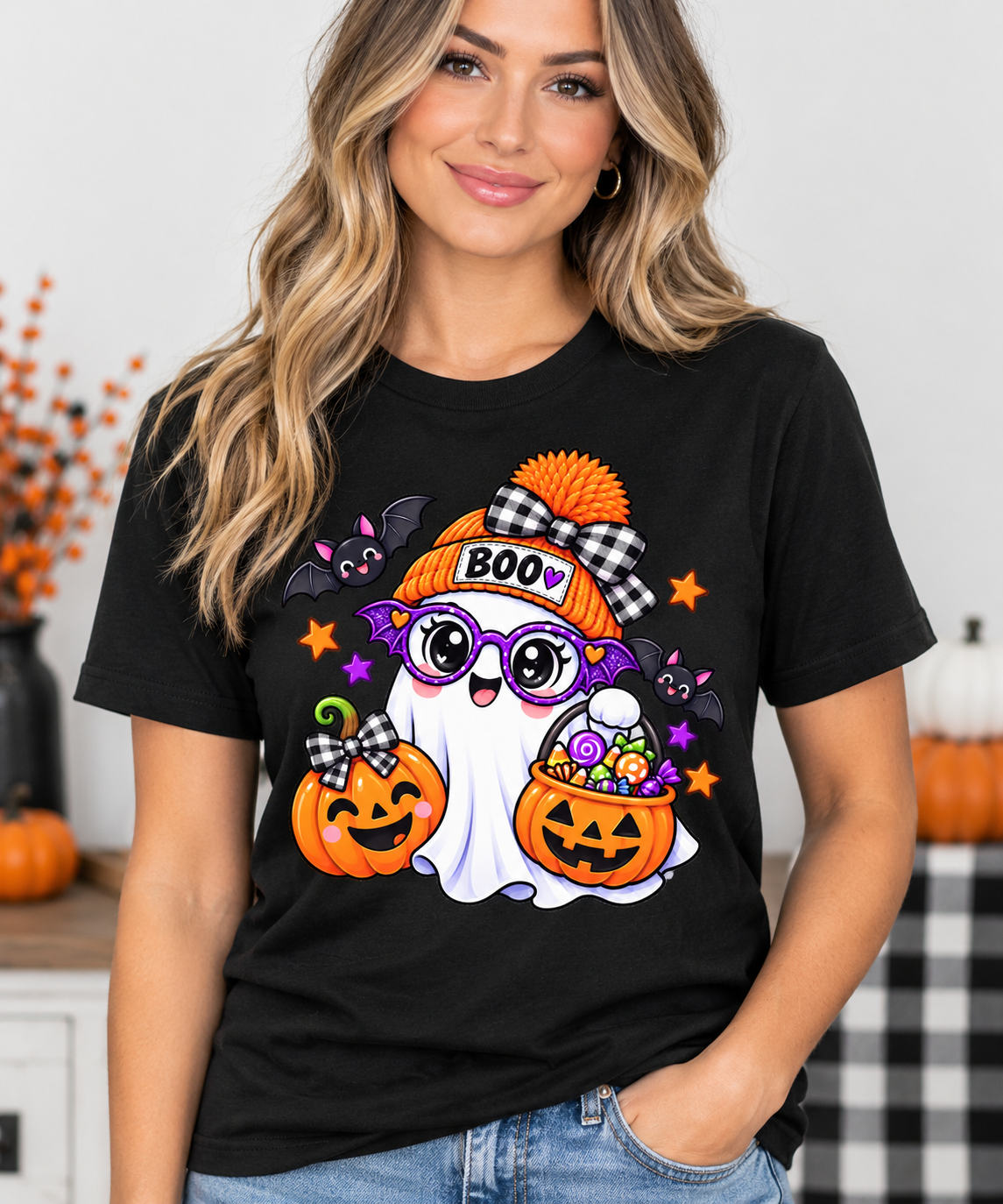 Cute white ghost wearing an orange BOO beanie and purple bat glasses, with smiling jack-o'-lantern pumpkins, candy, and bats, on a toddler Halloween t-shirt