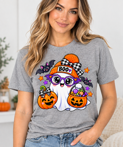 Cute white ghost wearing an orange BOO beanie and purple bat glasses, with smiling jack-o'-lantern pumpkins, candy, and bats, on a toddler Halloween t-shirt