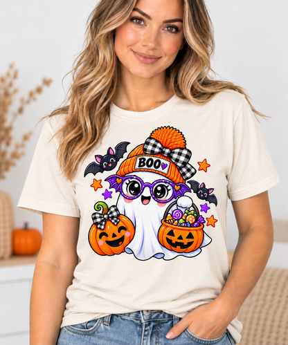 Cute white ghost wearing an orange BOO beanie and purple bat glasses, with smiling jack-o'-lantern pumpkins, candy, and bats, on a toddler Halloween t-shirt