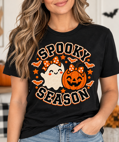 Close-up of faux embroidery texture on ghost and jack-o-lantern Halloween tee