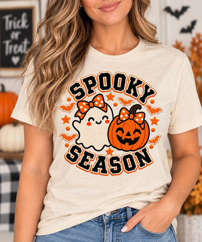 Person wearing Spooky Season Halloween t-shirt with ghost and pumpkin design
