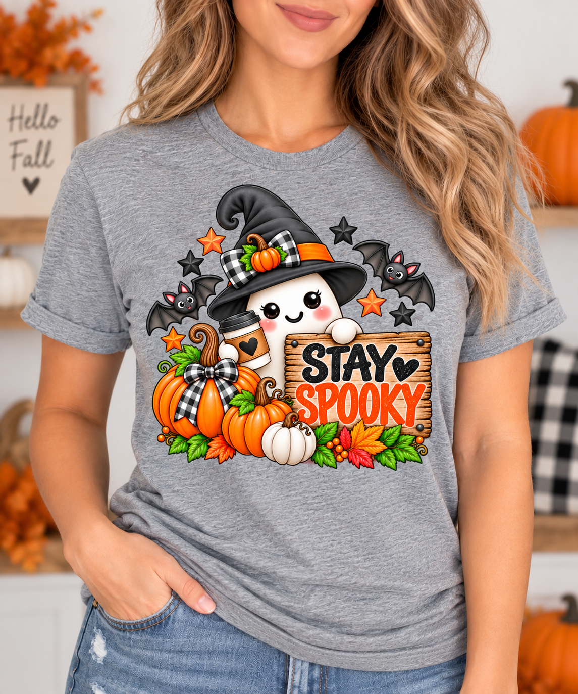 Woman wearing a heather grey t-shirt with cute ghost witch Stay Spooky Halloween design
